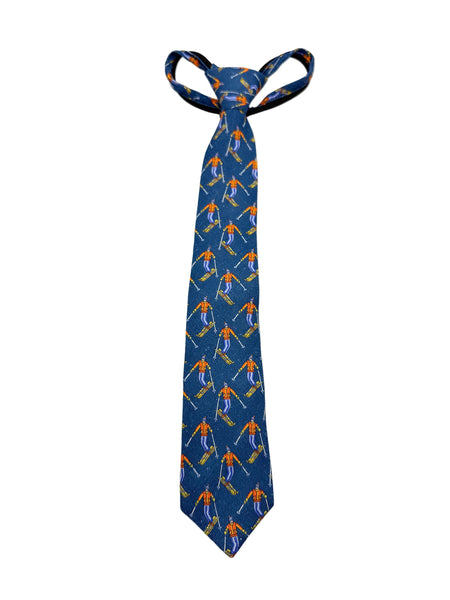 A blue necktie with a repeating pattern of skiers in orange and white, tied in a standard knot and displayed against a plain white background.