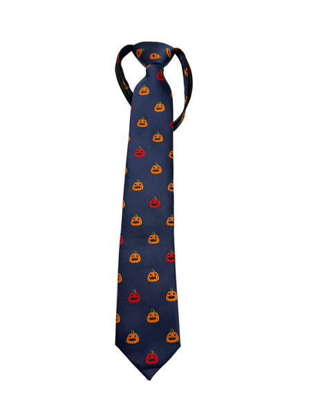 A navy blue necktie with a repeating pattern of orange and red jack-o'-lantern pumpkins, laid flat on a light gray background.