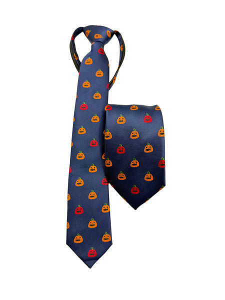 A navy blue necktie with a repeating pattern of small orange and red jack-o'-lantern pumpkins, displayed alongside a matching tie clip on a light gray background.